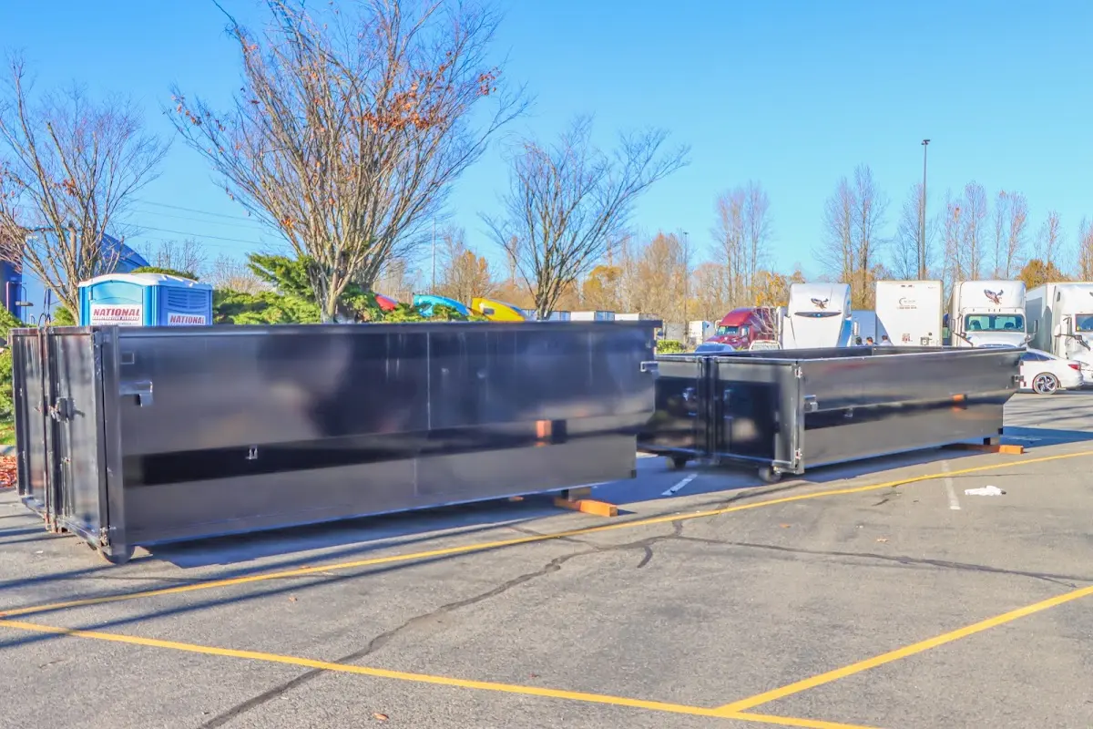 Professional dumpster rental service with roll-off container on residential driveway in On Top of the World